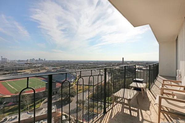 a view of a balcony with furniture