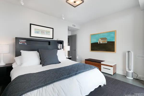 a living room with furniture a flat screen tv and a floor to ceiling window