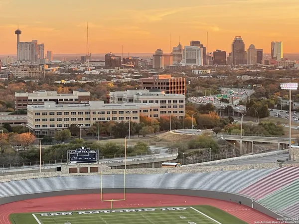 an aerial view of a house with a swimming pool and outdoor seating
