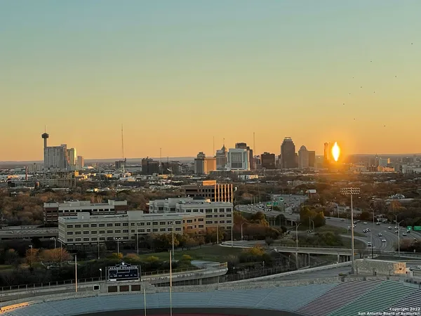 an aerial view of a house with a swimming pool and outdoor seating