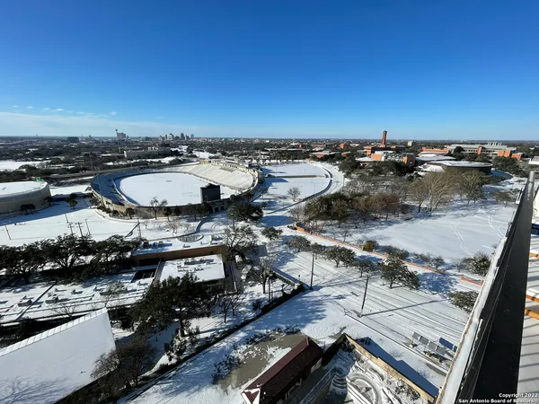 an aerial view of a house with a yard and potted plants