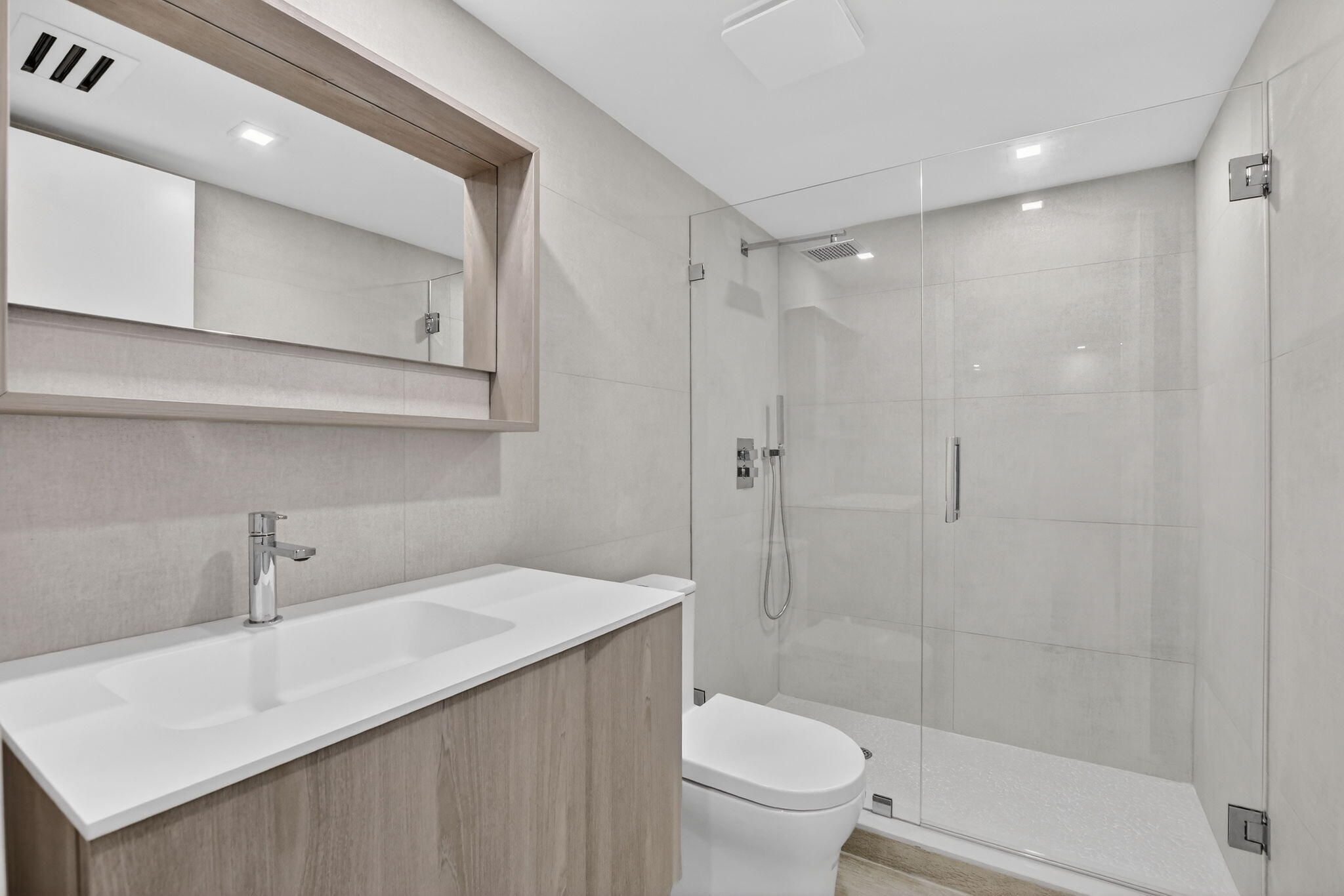 7835 Lakeside Boulevard, Unit 946 Boca Raton, FL 33434 - Photo 3 of 20 a bathroom with a sink a toilet and shower