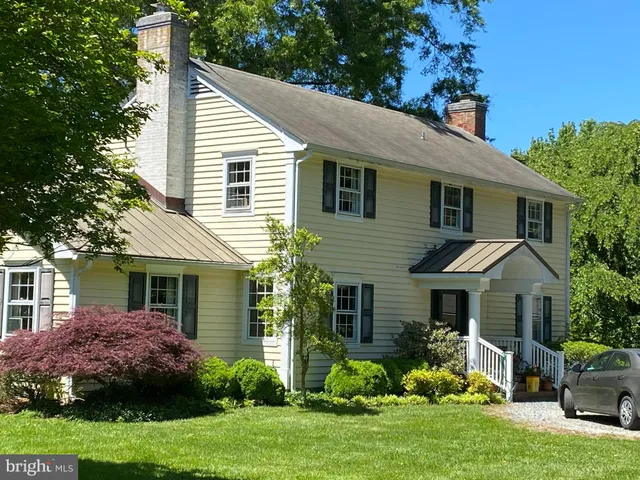 a front view of a house with a garden and plants
