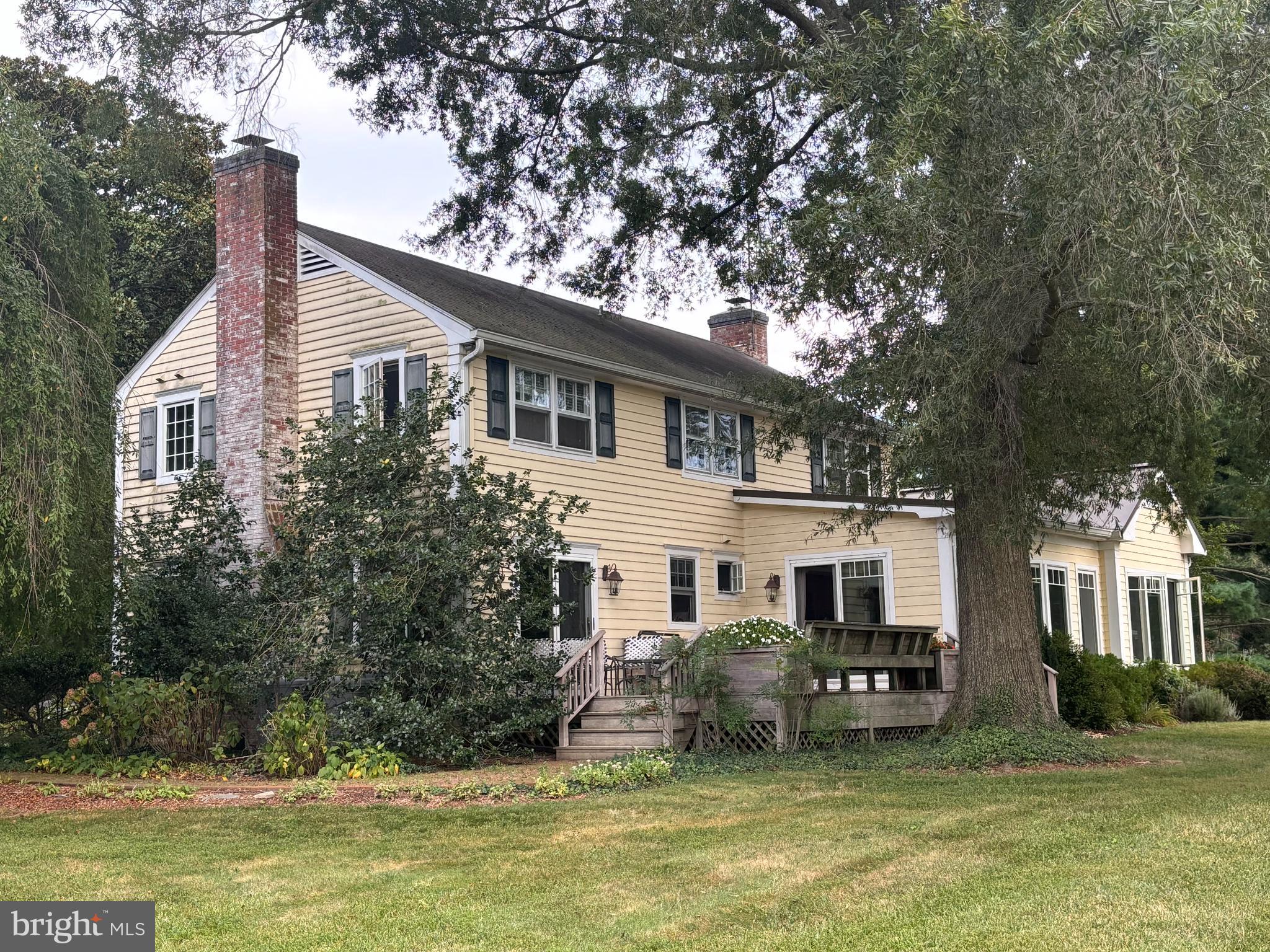 6680 Peachblossom Point Road Easton, MD 21601 - Photo 11 of 35 a white house that has a tree in front of it