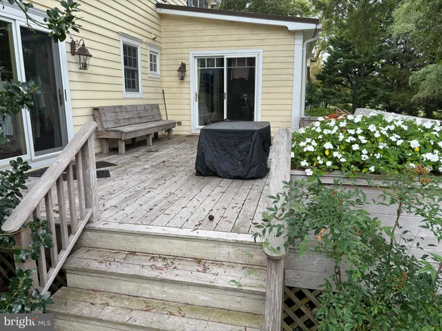 a view of backyard with deck and outdoor seating