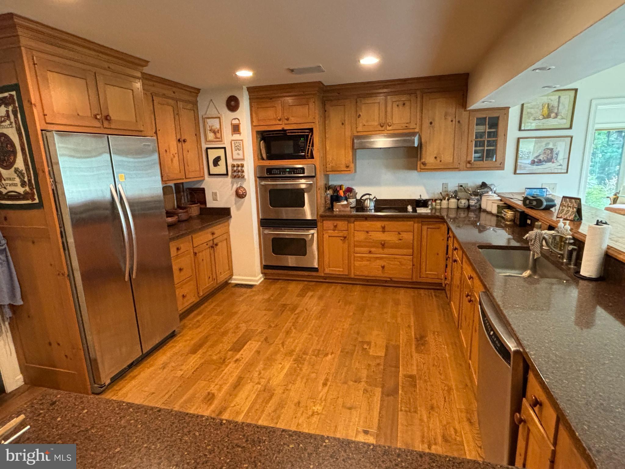 6680 Peachblossom Point Road Easton, MD 21601 - Photo 20 of 35 a kitchen with stainless steel appliances granite countertop a refrigerator stove top oven and sink