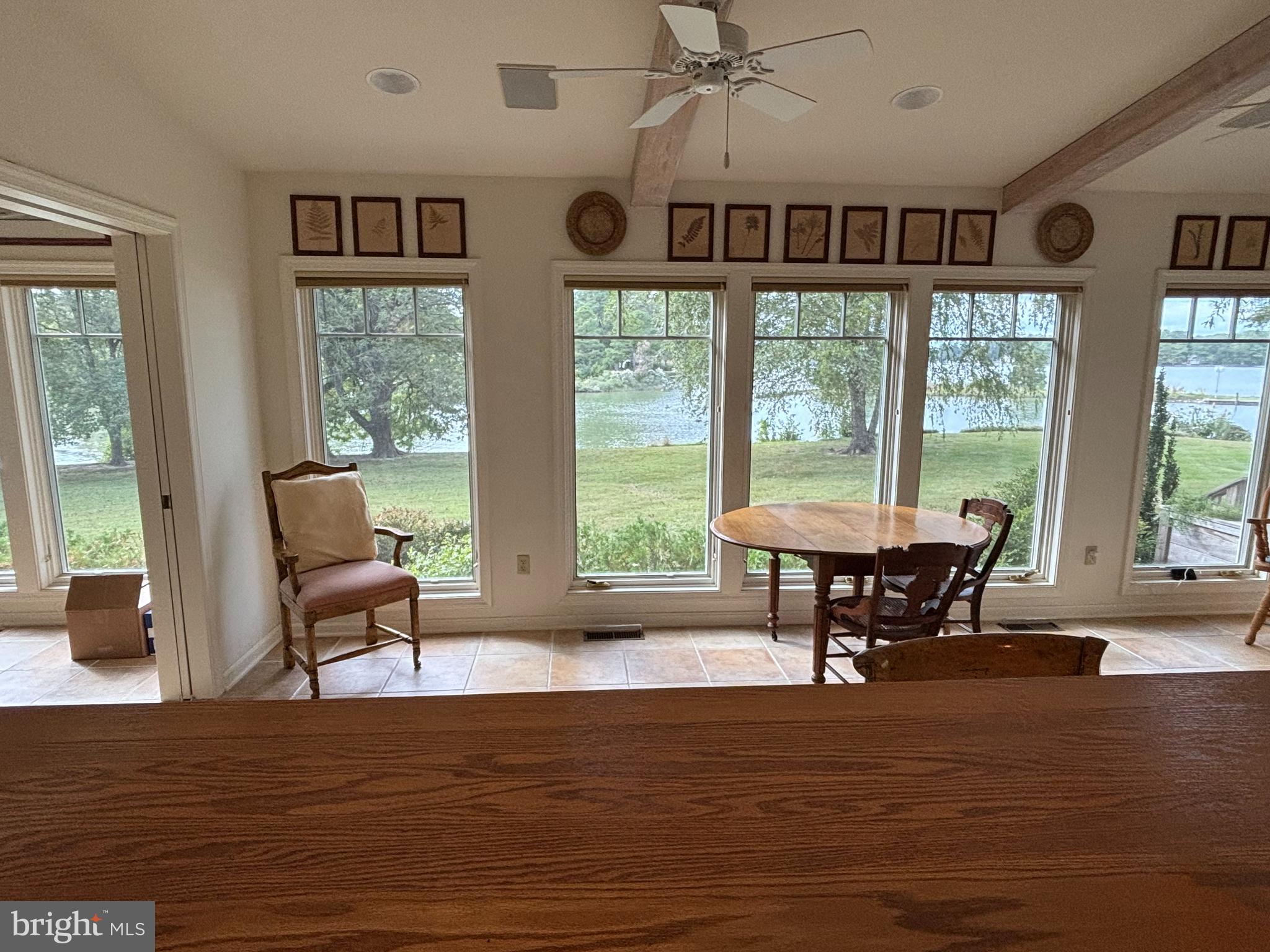 6680 Peachblossom Point Road Easton, MD 21601 - Photo 21 of 35 a view of a dining room with furniture window and wooden floor