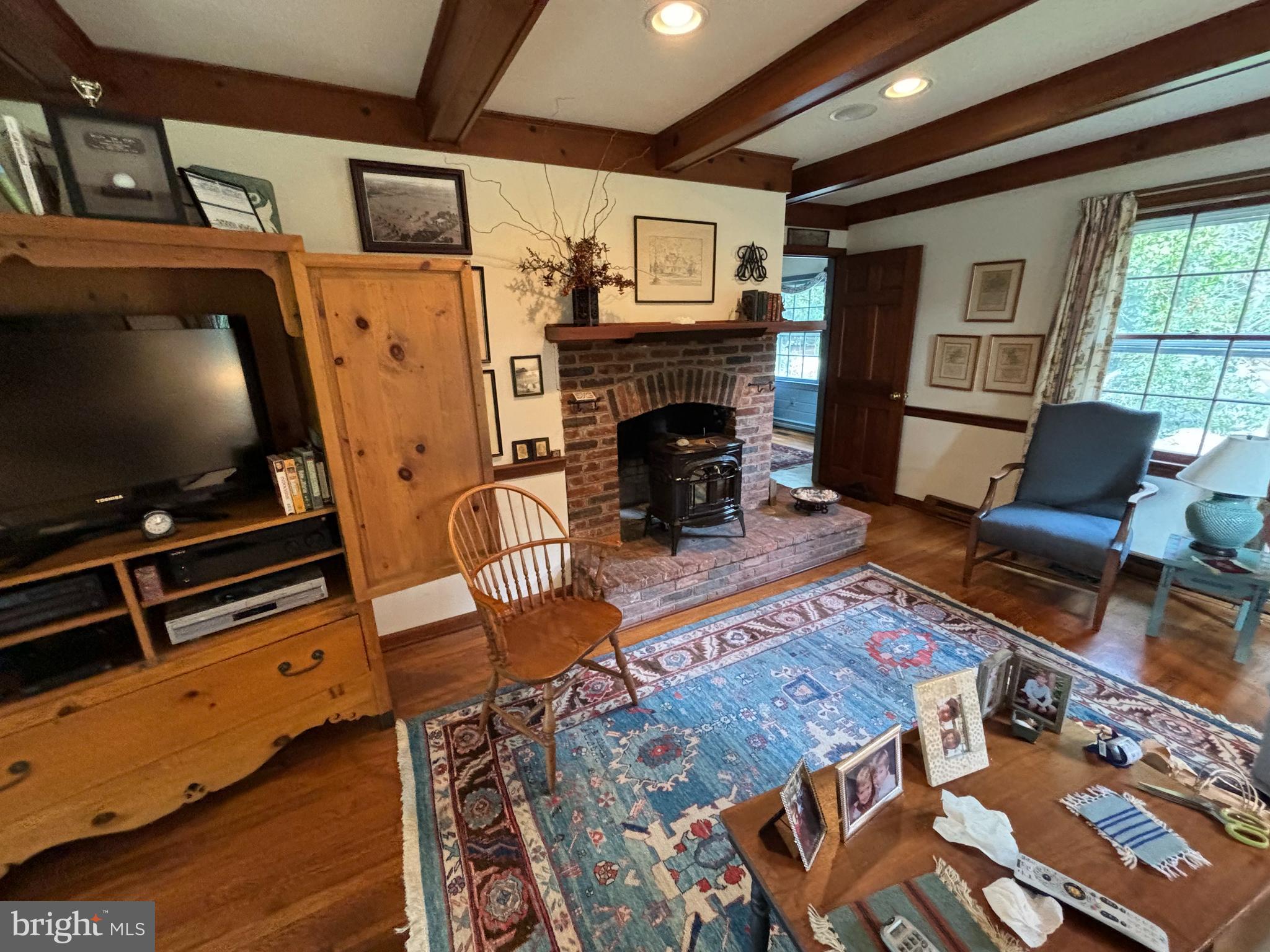 6680 Peachblossom Point Road Easton, MD 21601 - Photo 25 of 35 a living room with furniture a flat screen tv and a fireplace