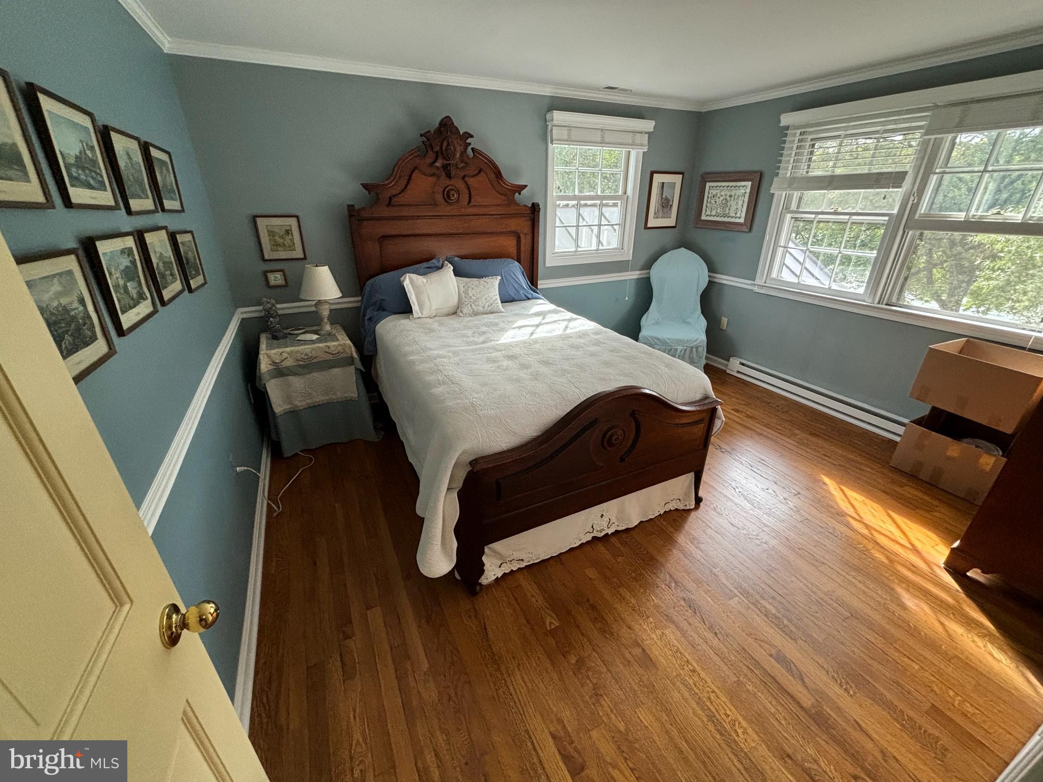 6680 Peachblossom Point Road Easton, MD 21601 - Photo 28 of 35 a bedroom with a bed window and wooden floor