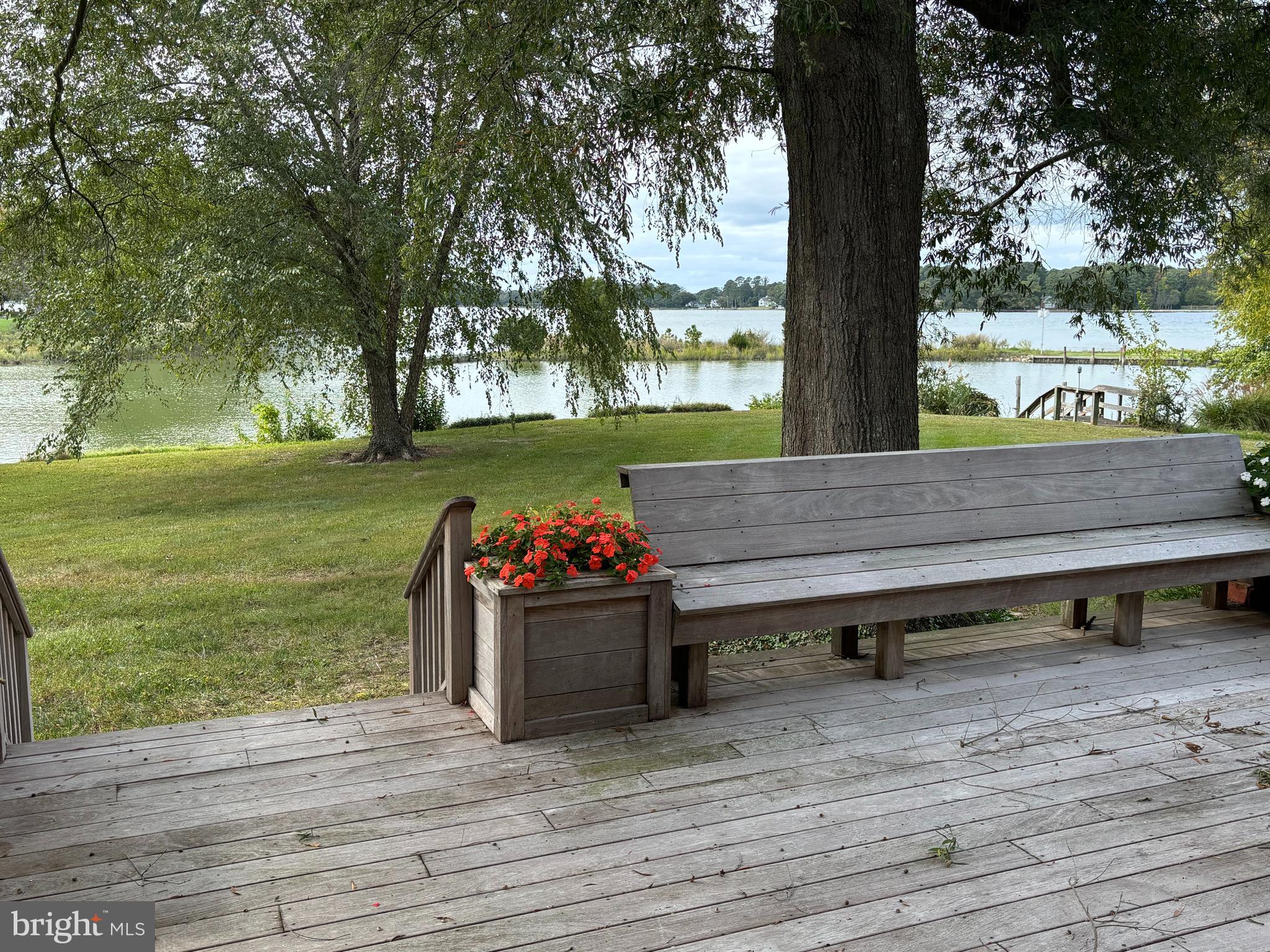 6680 Peachblossom Point Road Easton, MD 21601 - Photo 33 of 35 a view of a wooden floor and bench in the garden