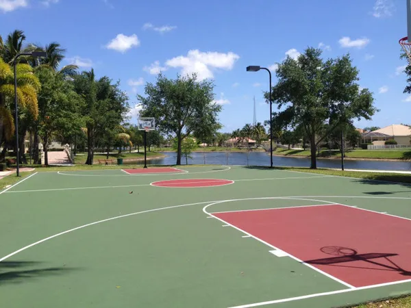 a front view of a house with a yard and palm trees