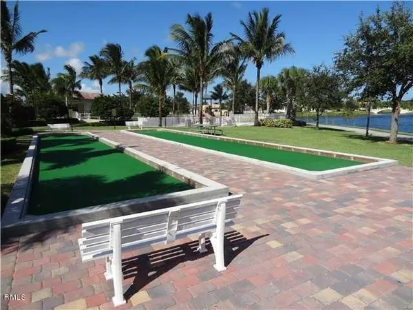 a view of a park with a slide swing and a slide
