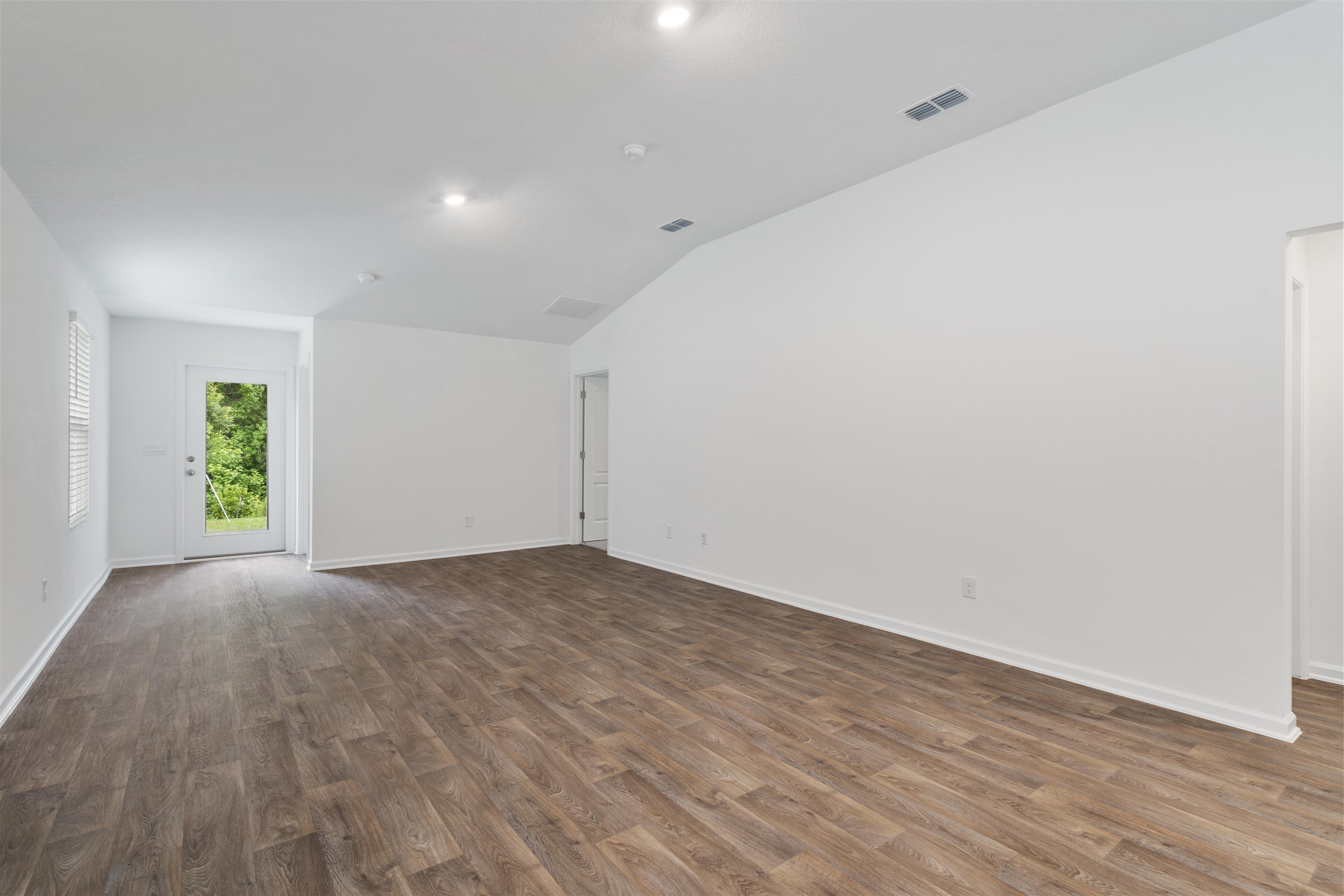 861 Orellana Road St. Augustine, FL 32084 - Photo 3 of 40 a view of an empty room with wooden floor and a window
