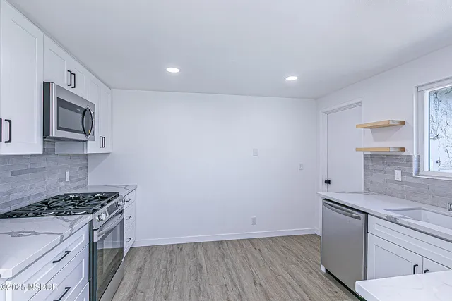 a kitchen with a sink stove and microwave