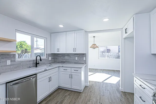 a kitchen with a sink stove and cabinets