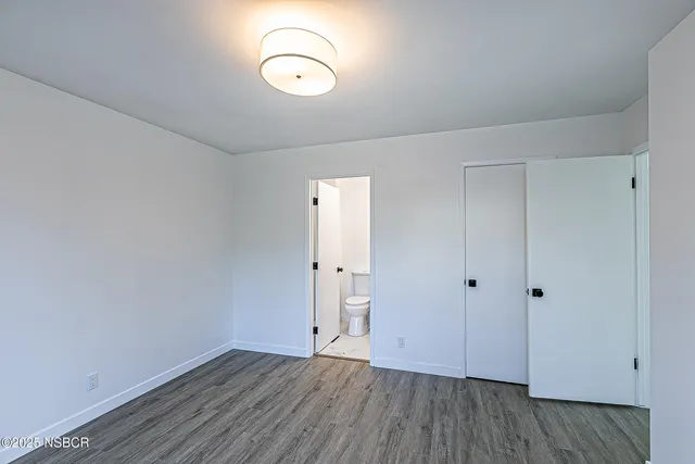 a view of room with wooden floor