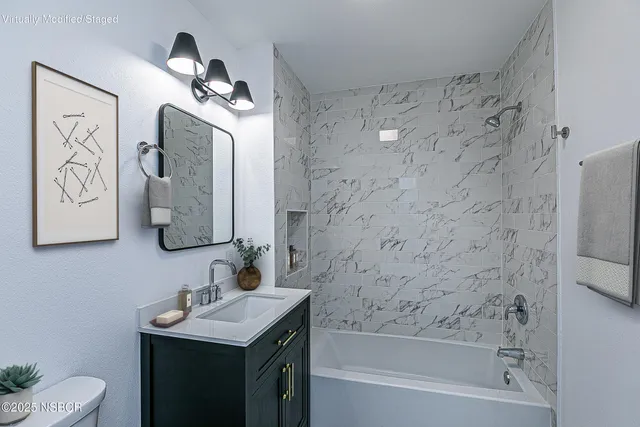 a bathroom with a sink a toilet and mirror