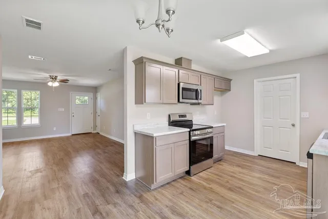 a kitchen with a stove top oven sink and microwave