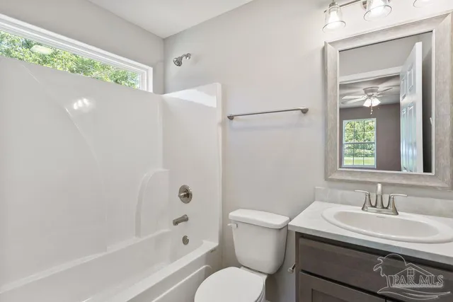 a bathroom with a sink toilet a mirror and shower