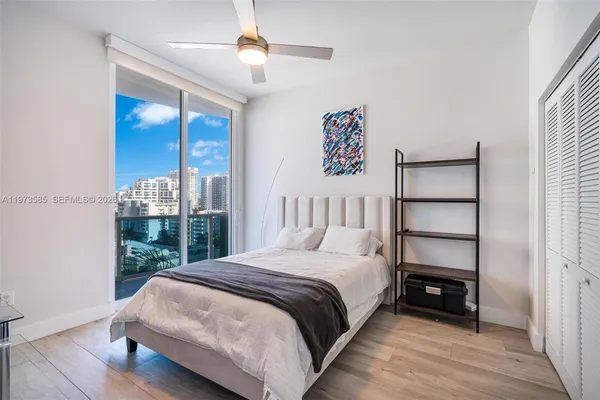 a bedroom with a bed a table and painting