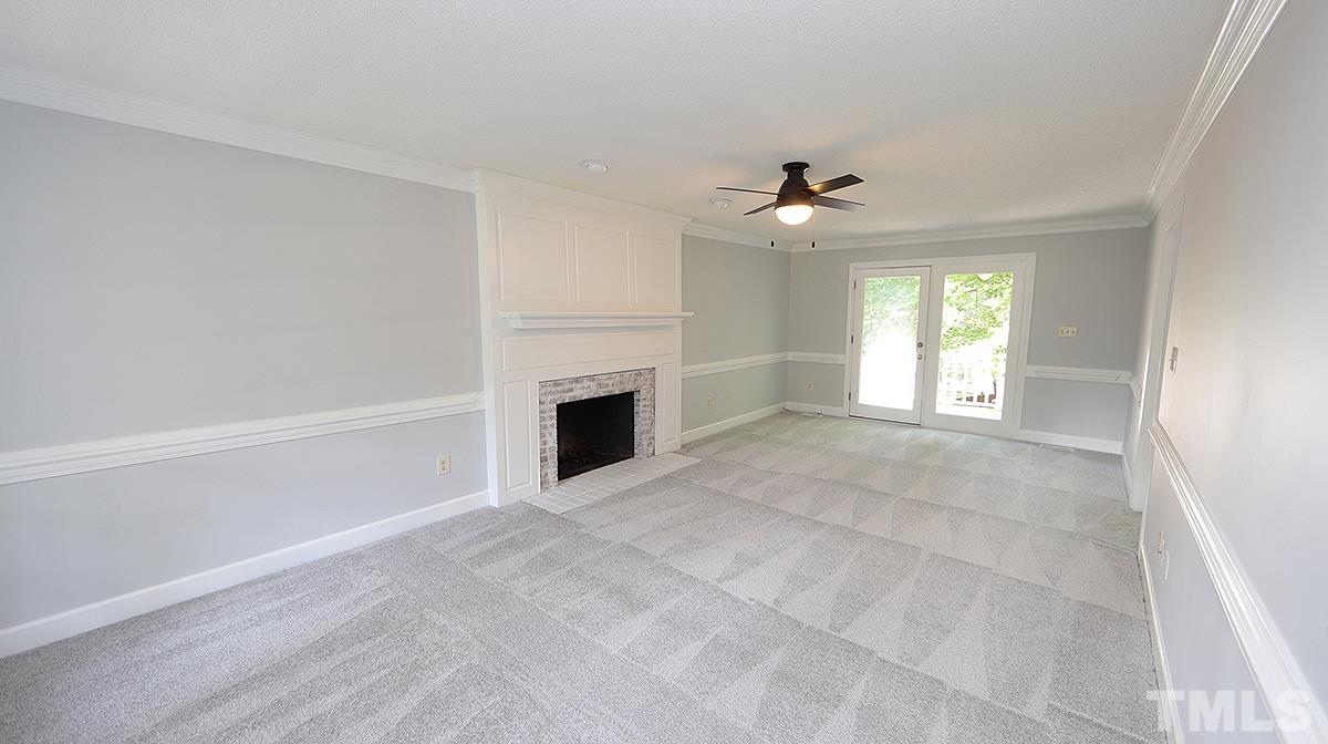 4505 Fortingale Circle Raleigh, NC 27613 - Photo 4 of 14 an empty room with windows and fireplace