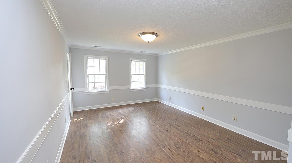 4505 Fortingale Circle Raleigh, NC 27613 - Photo 8 of 14 an empty room with wooden floor and windows