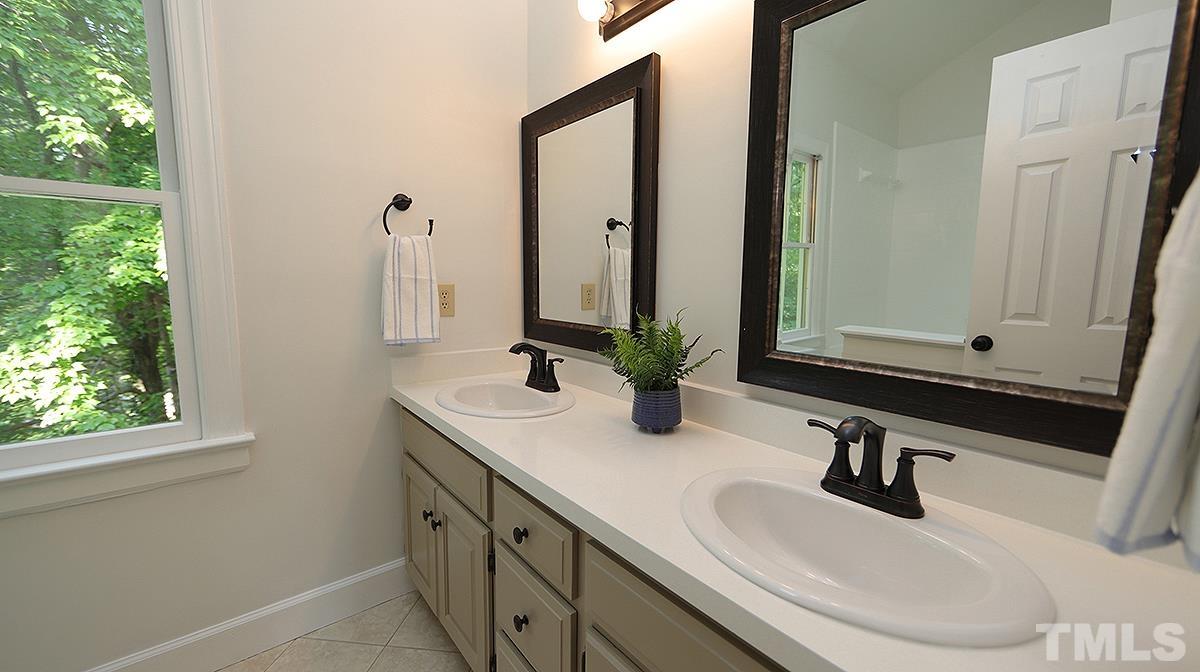 4505 Fortingale Circle Raleigh, NC 27613 - Photo 9 of 14 a bathroom with a sink and a mirror