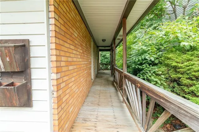 a view of balcony with wooden floor