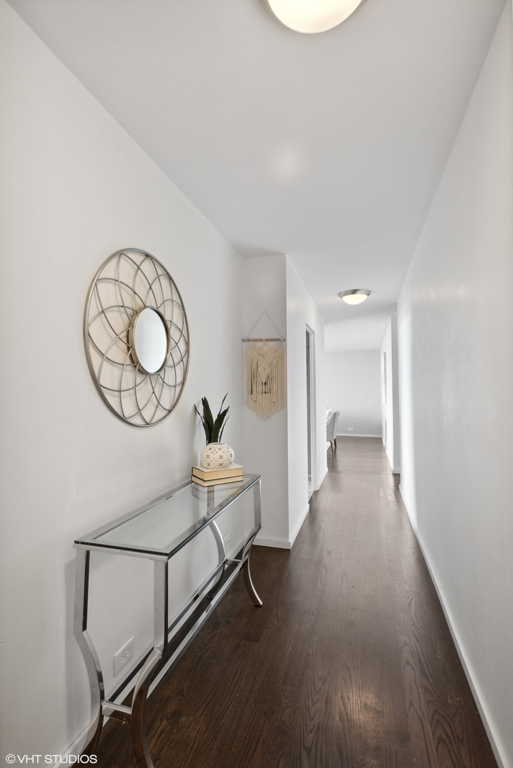 3430 North Lake Shore Drive, Unit 14P Chicago, IL 60657 - Photo 11 of 18 a view of a room with wooden floor fan and window
