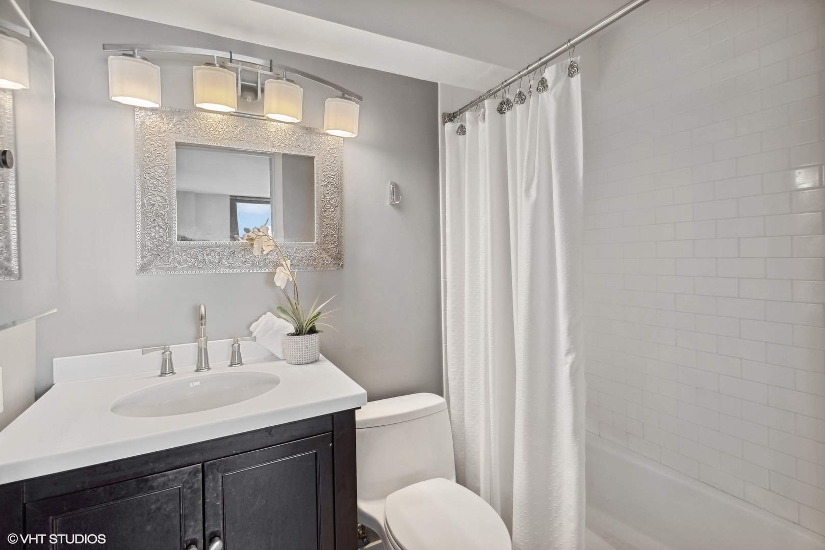 3430 North Lake Shore Drive, Unit 14P Chicago, IL 60657 - Photo 14 of 18 a bathroom with a sink toilet and shower