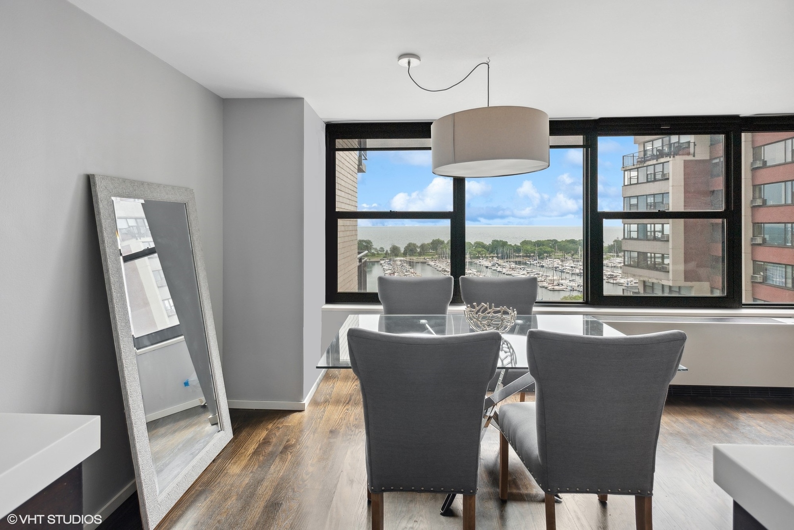 3430 North Lake Shore Drive, Unit 14P Chicago, IL 60657 - Photo 7 of 18 a dining room with furniture window wooden floor
