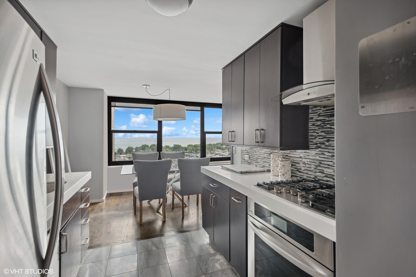 3430 North Lake Shore Drive, Unit 14P Chicago, IL 60657 - Photo 8 of 18 a kitchen with stainless steel appliances granite countertop a stove and a refrigerator