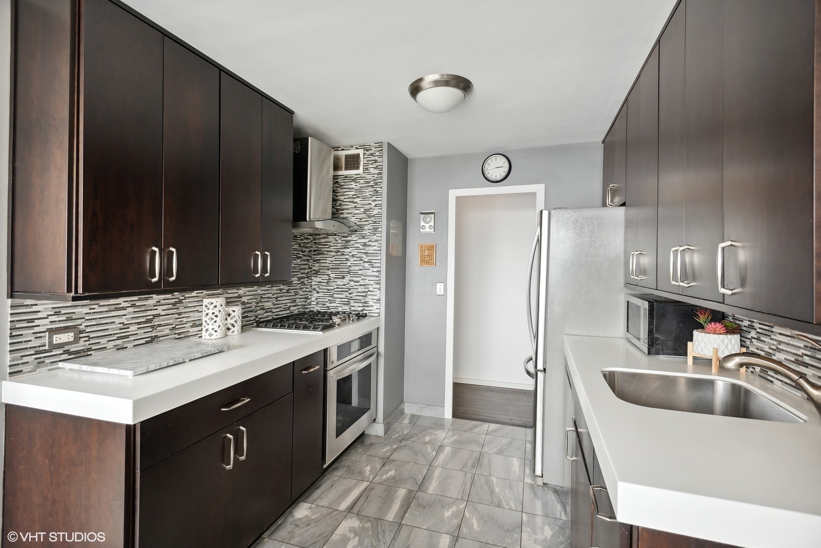 3430 North Lake Shore Drive, Unit 14P Chicago, IL 60657 - Photo 9 of 18 a kitchen with a sink stove and refrigerator