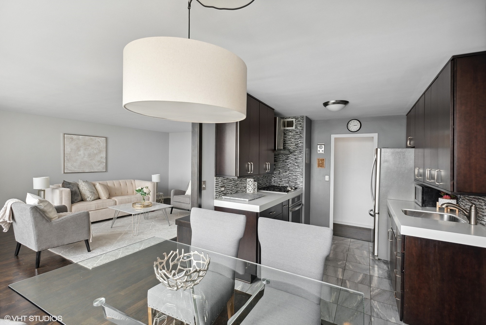 3430 North Lake Shore Drive, Unit 14P Chicago, IL 60657 - Photo 10 of 18 a living room with furniture and a chandelier