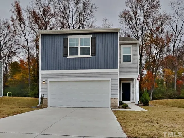 a front view of a house with yard