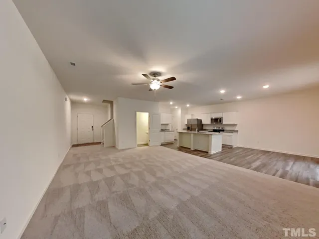 a view of a livingroom with a kitchen