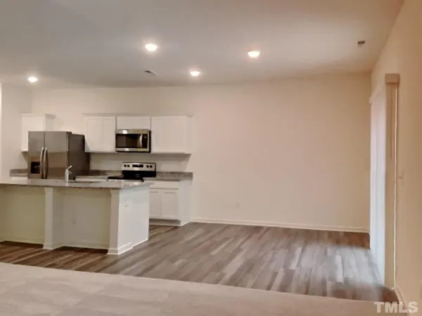 a kitchen with stainless steel appliances a refrigerator and microwave