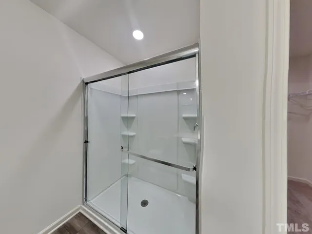 a bathroom with a glass shower door