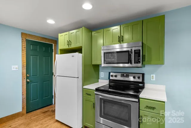 a kitchen with a refrigerator and a microwave