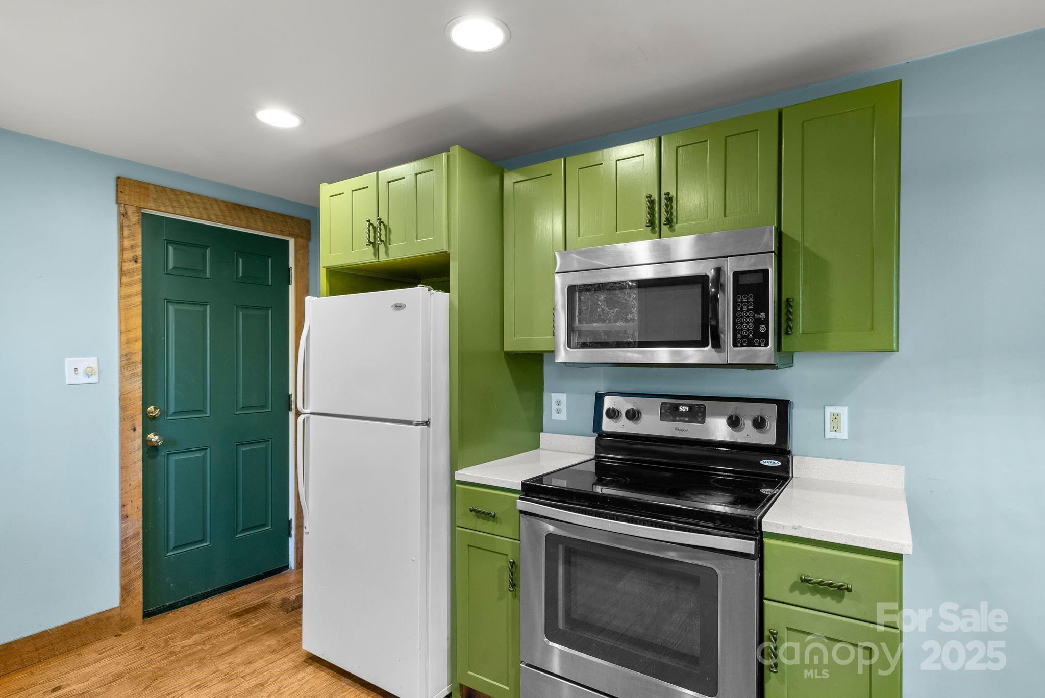 456 Rector Corner Road Marshall, NC 28753 - Photo 15 of 29 a kitchen with a refrigerator and a microwave