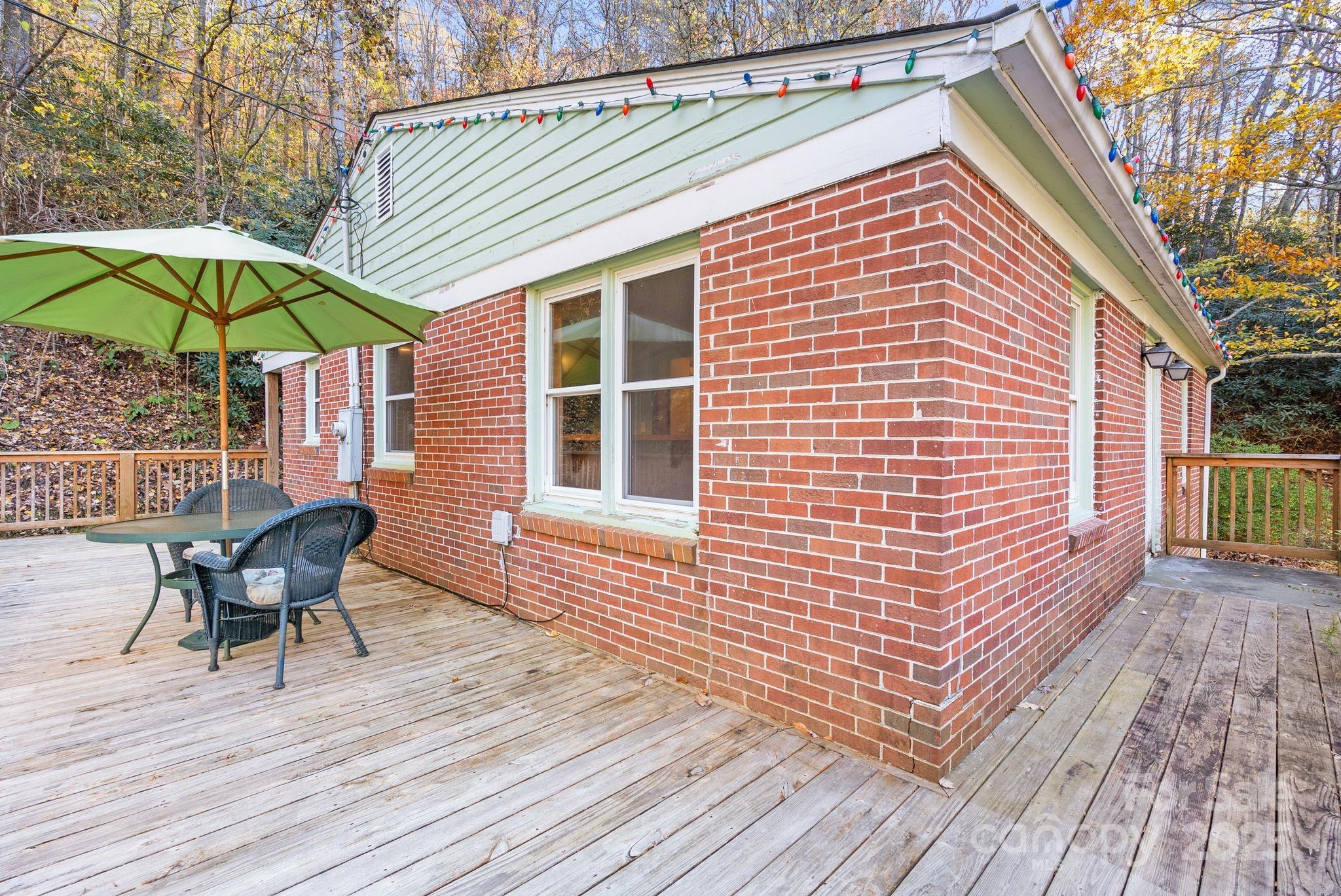 456 Rector Corner Road Marshall, NC 28753 - Photo 8 of 29 a deck with a table and chairs under an umbrella