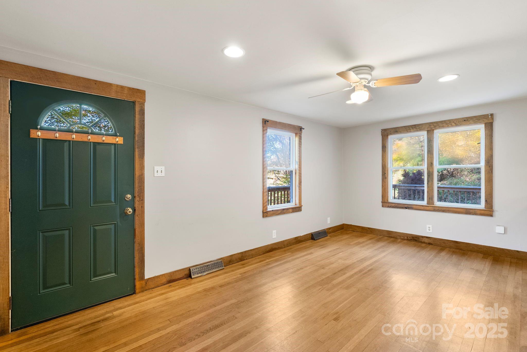 456 Rector Corner Road Marshall, NC 28753 - Photo 10 of 29 a view of an empty room with a window and wooden floor