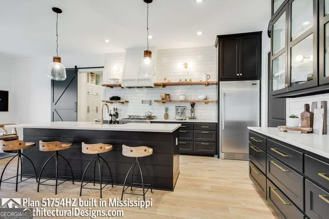 a kitchen with stainless steel appliances kitchen island granite countertop a sink and cabinets