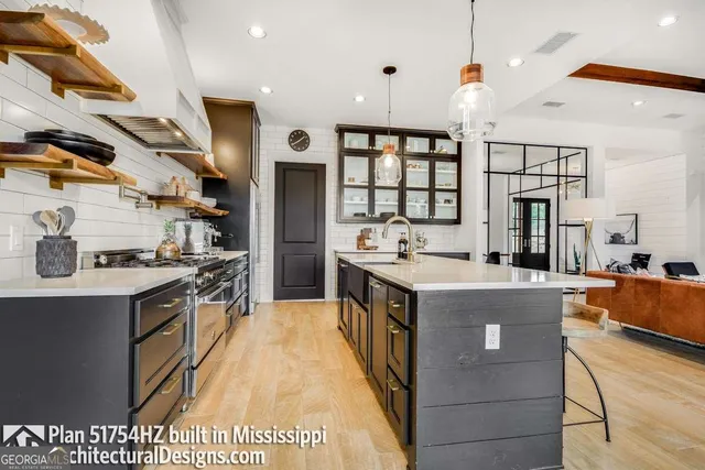 a kitchen with stainless steel appliances granite countertop a stove and a sink