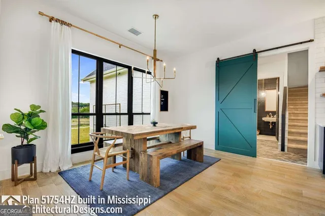 a living room with furniture a window and a table