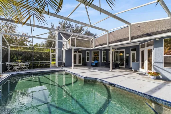 an aerial view of residential house with outdoor space and swimming pool