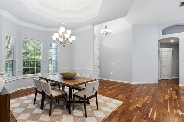 a view of a dining room with furniture and chandelier