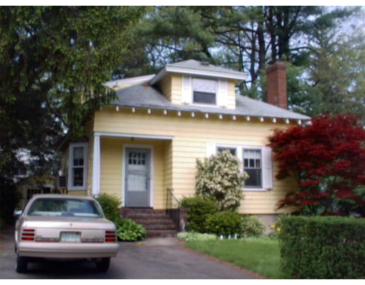175 Woodcliff Road Newton, MA 02461 - Photo 1 of 6 a front view of a house with a yard and garage