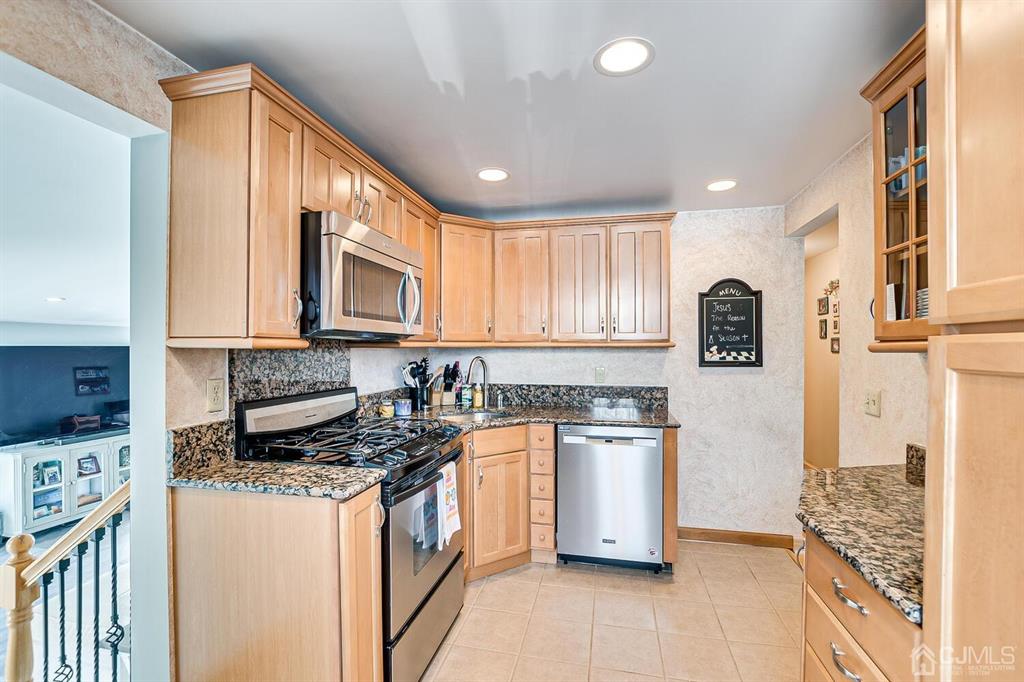 13 Highfield Road Colonia, NJ 07067 - Photo 14 of 42 a kitchen with stainless steel appliances granite countertop a stove a sink and a refrigerator