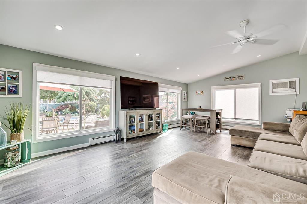 13 Highfield Road Colonia, NJ 07067 - Photo 16 of 42 a living room with furniture and a flat screen tv